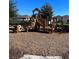 Community playground with wood chips and climbing structures for to play on at 604 Sarner Pass Way, Winter Haven, FL 33881