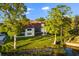 This backyard features lush greenery, mature trees, and a view of the waterfront, all with abundant natural light at 640 Killarney Bay Ct # 4, Winter Park, FL 32789