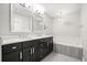 Modern bathroom features dual sinks, marble countertops and a soaking tub at 640 Killarney Bay Ct # 4, Winter Park, FL 32789