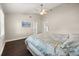 This bedroom features wood floors, a ceiling fan and access to an ensuite bath at 640 Killarney Bay Ct # 4, Winter Park, FL 32789
