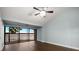 Bedroom with wood floors, ceiling fan, and a stunning lake view from balcony at 640 Killarney Bay Ct # 4, Winter Park, FL 32789