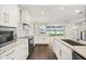 Contemporary kitchen with granite countertops, stainless appliances, and a scenic view at 640 Killarney Bay Ct # 4, Winter Park, FL 32789