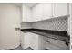 Laundry room features black granite countertops and white cabinetry at 640 Killarney Bay Ct # 4, Winter Park, FL 32789