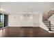 Open-concept living room features wood floors, staircase, and custom built-ins at 640 Killarney Bay Ct # 4, Winter Park, FL 32789