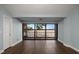 Bright living room features hardwood floors, large windows with lake views and access to balcony at 640 Killarney Bay Ct # 4, Winter Park, FL 32789
