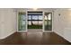Inviting living room boasts gleaming hardwood floors and sliding glass doors with serene lake views at 640 Killarney Bay Ct # 4, Winter Park, FL 32789
