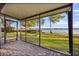 Screened patio boasts stone pavers and a tranquil view of the lawn and lake at 640 Killarney Bay Ct # 4, Winter Park, FL 32789