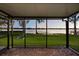 Relaxing screened patio with brick pavers offers a peaceful view of the tranquil lake at 640 Killarney Bay Ct # 4, Winter Park, FL 32789