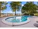 Enjoy community pool with a view of the water and ample seating for relaxation and recreation at 640 Killarney Bay Ct # 4, Winter Park, FL 32789
