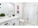 Modern bathroom featuring a vanity with white countertop, a glass-enclosed shower and dark hardware at 7409 Inlet Pt, Celebration, FL 34747