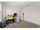 An empty bedroom with carpeted floor, white walls, and an ensuite bathroom entrance at 7409 Inlet Pt, Celebration, FL 34747