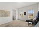 An empty bedroom with carpeted floor, white walls, and views from the two large windows at 7409 Inlet Pt, Celebration, FL 34747