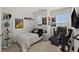 The bedroom features decorative wall art, a large desk with computer, and natural light from the windows at 7409 Inlet Pt, Celebration, FL 34747