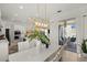 Open concept kitchen and dining room with woven chairs and modern lighting at 7409 Inlet Pt, Celebration, FL 34747