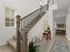 Bright entryway featuring a staircase with black iron railings, neutral decor, and tiled flooring at 7409 Inlet Pt, Celebration, FL 34747