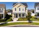 Inviting two-story home with a covered front porch and lush landscaping at 7409 Inlet Pt, Celebration, FL 34747