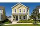 Charming two-story home with a welcoming front porch, lush landscaping, and a well-maintained lawn at 7409 Inlet Pt, Celebration, FL 34747