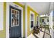 Charming front porch with decorative door and comfortable seating, creating a welcoming entryway at 7409 Inlet Pt, Celebration, FL 34747