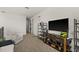 Bright upstairs hallway with a TV and shelving, leading to various rooms in the home at 7409 Inlet Pt, Celebration, FL 34747