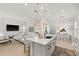 Stylish kitchen island with seating, stainless steel sink, and view of the living area, offering an open-concept design at 7409 Inlet Pt, Celebration, FL 34747