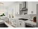 A modern kitchen features white cabinets, quartz countertops, and stainless steel appliances at 7409 Inlet Pt, Celebration, FL 34747