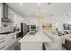Open kitchen with long island, white cabinets, stainless appliances, and seating area at 7409 Inlet Pt, Celebration, FL 34747
