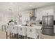 Bright and spacious kitchen with a center island, white countertops, stylish pendant lights, and seating for four at 7409 Inlet Pt, Celebration, FL 34747