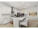 Well-lit kitchen features white cabinets, a central island with seating, and modern stainless steel appliances at 7409 Inlet Pt, Celebration, FL 34747