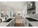 Modern kitchen with tile flooring, white cabinets, stainless steel appliances, and an island at 7409 Inlet Pt, Celebration, FL 34747
