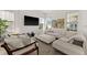 Comfortable living room showcasing neutral furniture, a large flat screen TV, and abundant natural light at 7409 Inlet Pt, Celebration, FL 34747