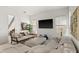 Bright and spacious living room with comfortable seating, a flat screen TV, and large windows at 7409 Inlet Pt, Celebration, FL 34747