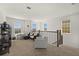 Upstairs living room featuring carpet flooring, stylish furniture, and large windows for abundant natural light at 7409 Inlet Pt, Celebration, FL 34747
