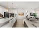 Open floor plan showcasing a kitchen island with bar seating and a bright living room with stylish decor at 7409 Inlet Pt, Celebration, FL 34747