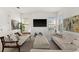 Cozy living room with bright white walls, neutral-toned furniture, and large windows providing plenty of light at 7409 Inlet Pt, Celebration, FL 34747