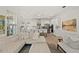 Bright living room featuring white couches, tile floors, and an open floor plan connected to the kitchen at 7409 Inlet Pt, Celebration, FL 34747