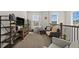 Cozy upstairs living room filled with natural light, comfortable seating, and decorative shelving units at 7409 Inlet Pt, Celebration, FL 34747