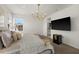 Main bedroom with a chandelier, mounted TV, mini-fridge and view into the bathroom at 7409 Inlet Pt, Celebration, FL 34747