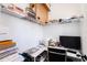 A well organized small office with white walls, desk, and storage shelves at 7409 Inlet Pt, Celebration, FL 34747