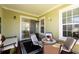 Inviting covered patio with comfortable seating, ideal for relaxation and outdoor enjoyment at 7409 Inlet Pt, Celebration, FL 34747