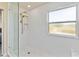 Modern bathroom shower with glass door, gold fixtures, white subway tile, and hexagon tile floor at 7545 Azalea Cove Cir, Orlando, FL 32807