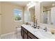 Bathroom with double sink vanity, granite countertop, and vanity lighting at 7545 Azalea Cove Cir, Orlando, FL 32807