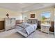 Comfortable bedroom featuring neutral colors, a bed, windows and matching furniture at 7545 Azalea Cove Cir, Orlando, FL 32807