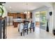 Elegant dining area featuring a chandelier, dark wood cabinets, and sliding glass doors to the backyard at 7545 Azalea Cove Cir, Orlando, FL 32807
