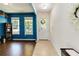 Bright foyer with tile flooring leading into a living space featuring hardwood floors and large windows at 7545 Azalea Cove Cir, Orlando, FL 32807