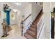 Open foyer featuring tile flooring, staircase, decorative wreaths and view to the front door at 7545 Azalea Cove Cir, Orlando, FL 32807