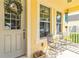Charming front porch featuring comfortable seating, a decorative wreath, and classic architectural details at 7545 Azalea Cove Cir, Orlando, FL 32807