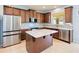 Well-equipped kitchen featuring stainless steel appliances, dark wood cabinets, and a marble countertop island at 7545 Azalea Cove Cir, Orlando, FL 32807