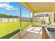 Relax in this screened lanai with a view of the spacious, fenced backyard and an in-ground spa at 7545 Azalea Cove Cir, Orlando, FL 32807