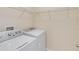 Laundry room featuring a washing machine and dryer, as well as wire shelving at 7545 Azalea Cove Cir, Orlando, FL 32807