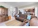 Spacious living room with a brown sectional sofa, tile floors, and an open view into the kitchen at 7545 Azalea Cove Cir, Orlando, FL 32807